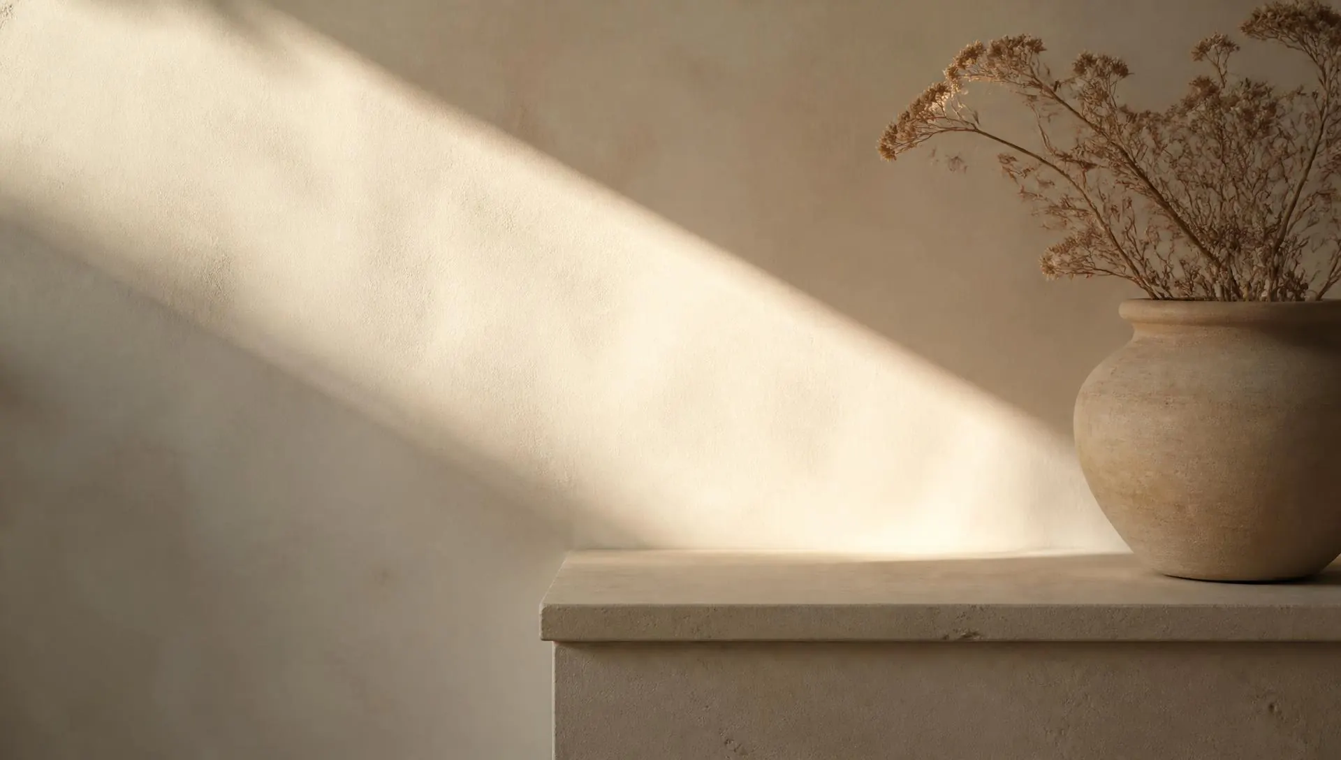 A soft diagonal of sunlight across a warm cream wall, frequently asked questions at Harlan Therapy